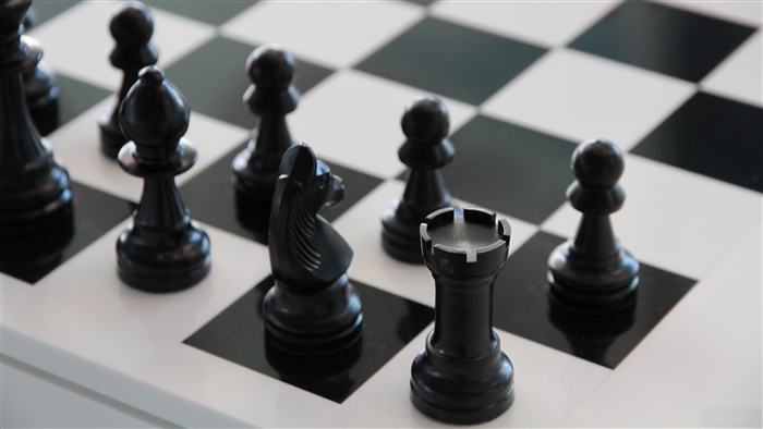 Black chess pieces on a chessboard 4K