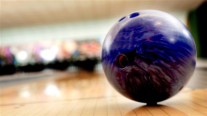 Purple and blue bowling ball on a lane
