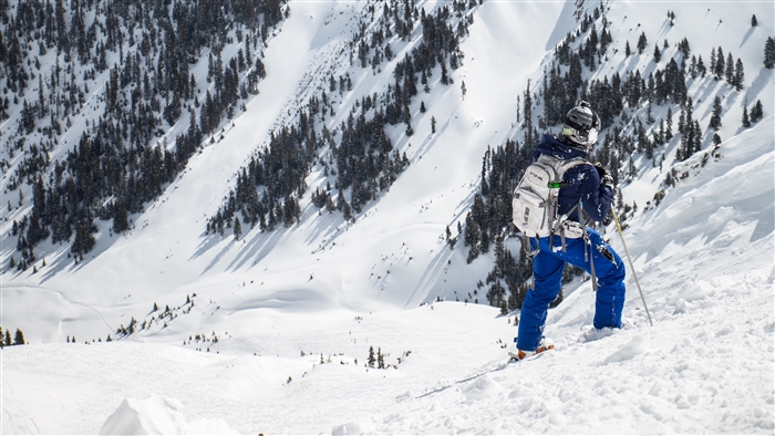 Skier on snowy mountain slope in winter 4K