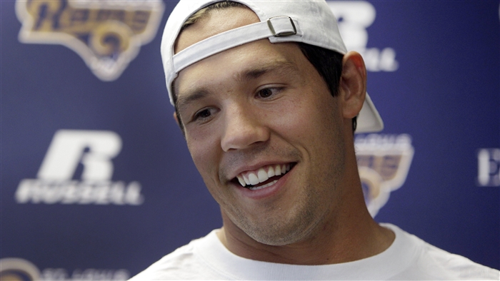 Sam Bradford wearing a Rams hat