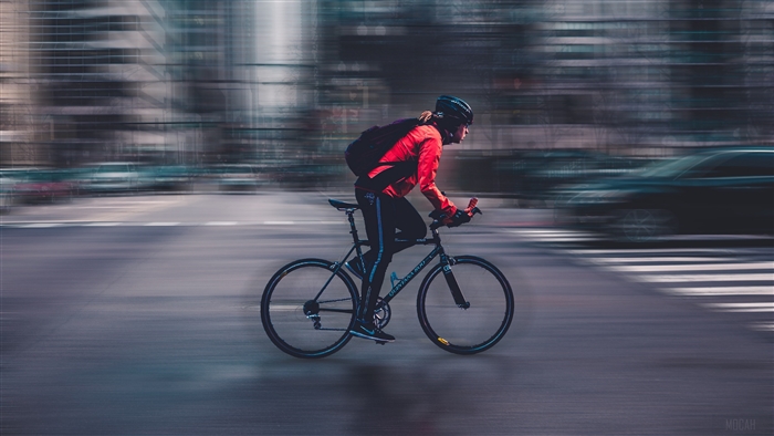 Cyclist in motion on a city street 4K