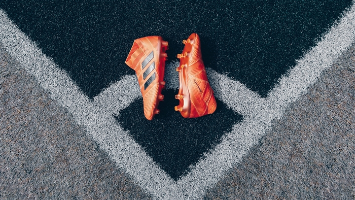 Adidas football boots on a sports field