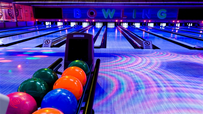 Bowling alley with colorful lights and bowling balls