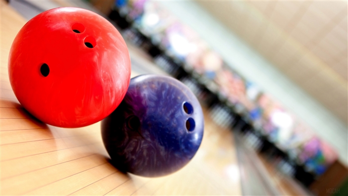 Red and purple bowling balls on a lane 4K