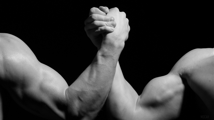 Two men arm wrestling in black and white