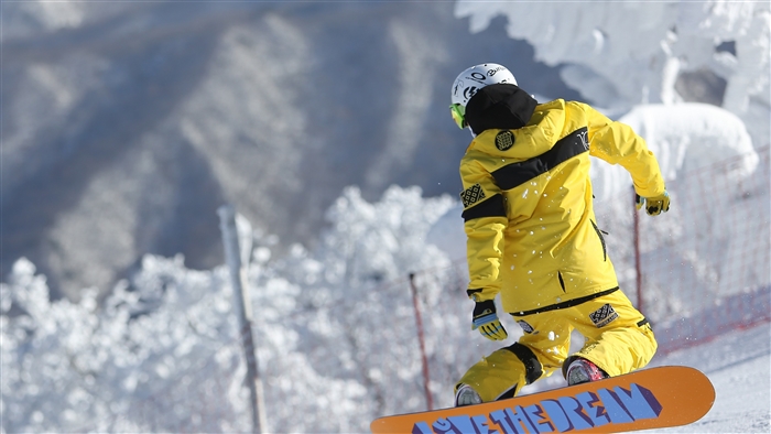 Snowboarder performing a trick in the snow 4K