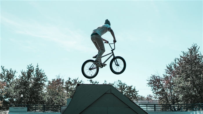 BMX biker performing a jump trick 4K