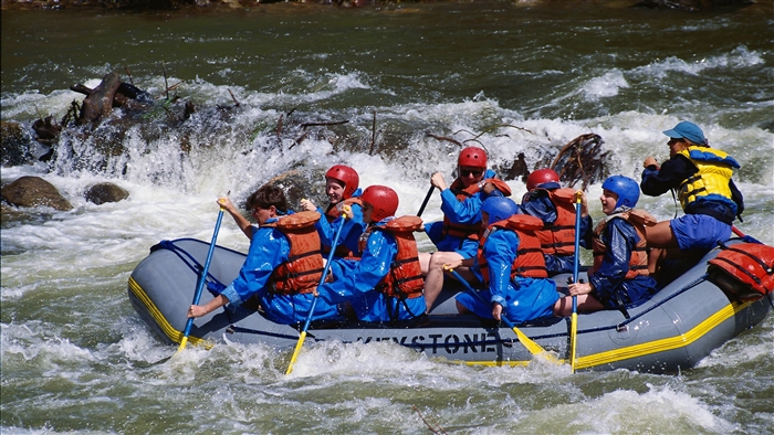 People whitewater rafting on a river