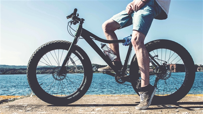 Cyclist on a fat tire bicycle by a river