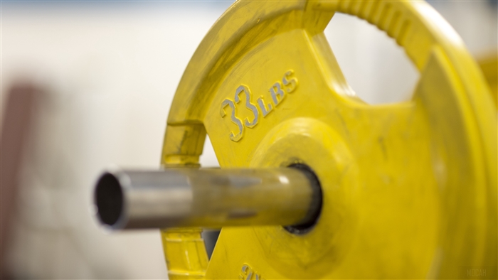 Yellow 33 LBS Weight Plate on Barbell