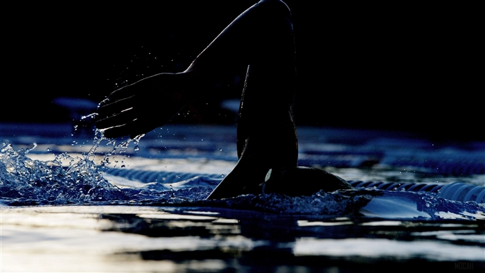 Swimmer's hand emerging from water in swimming pool 4K