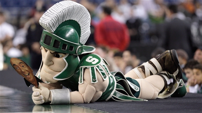Sparty the Michigan State Mascot holding a cutout of Tom Izzo