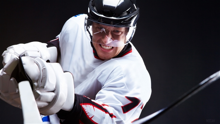 Hockey player with grin and hockey stick