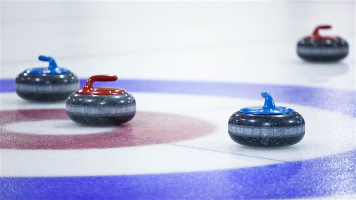 Curling stones on ice rink
