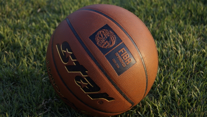 Basketball on grass with FIBA logo