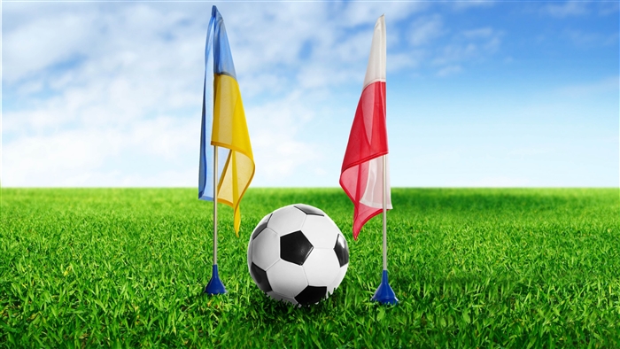 Football with Ukraine and Poland flags on grass 4K