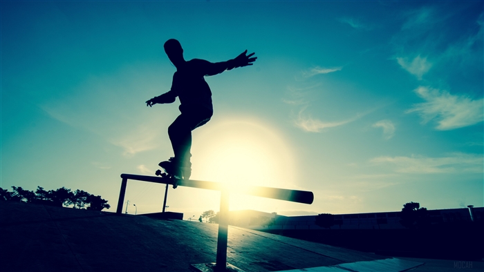 Silhouette of Skateboarder Grinding Rail at Sunset