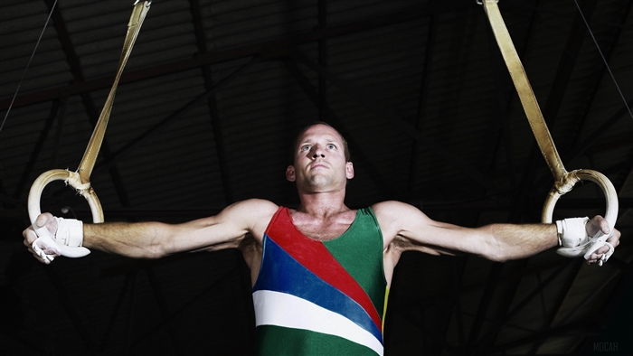 Gymnast performing on rings 4K
