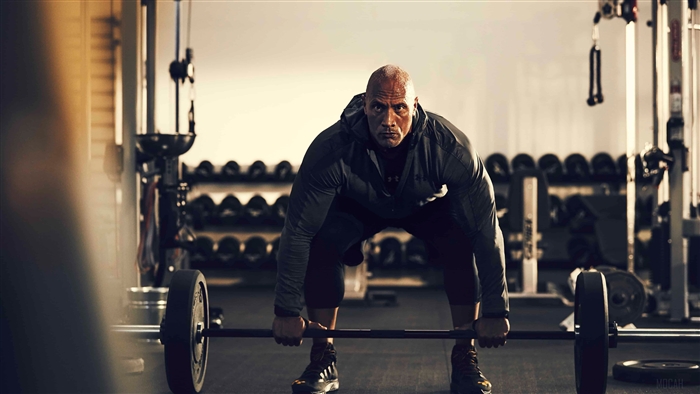 Dwayne Johnson lifting weights in a gym