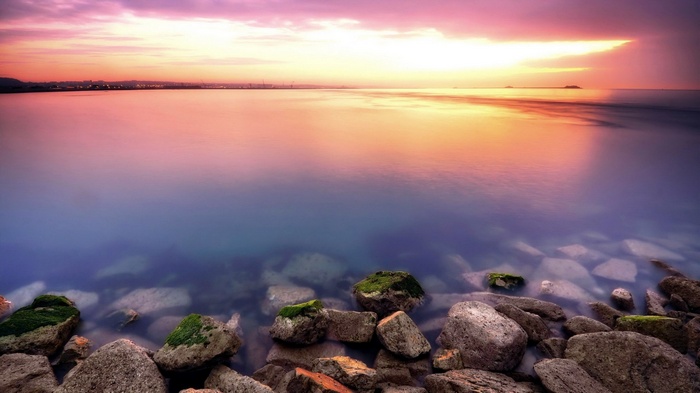 Rocky Shoreline at Sunset with Colorful Sky