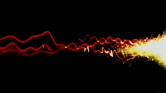 Wavy red and yellow light burst on black background 4K