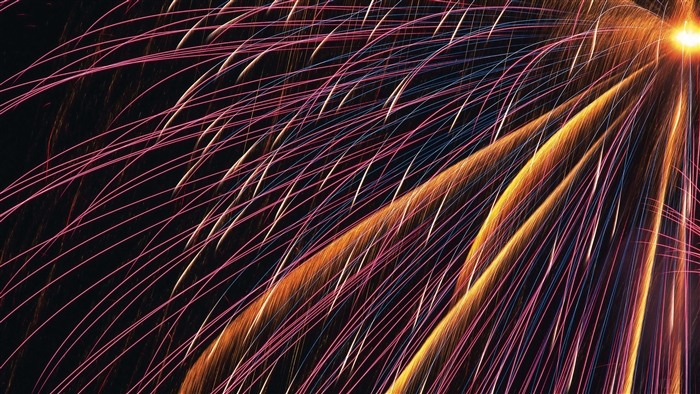 Bright fireworks with pink and orange streaks
