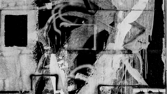 Graffiti art with stains and lines on a wall