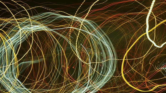 Abstract light trails in yellow, white, and red