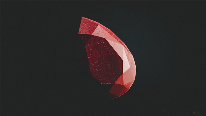 Red faceted gemstone on a dark background