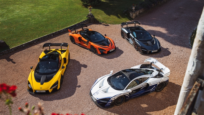 Four McLaren Senna cars in a gravel driveway