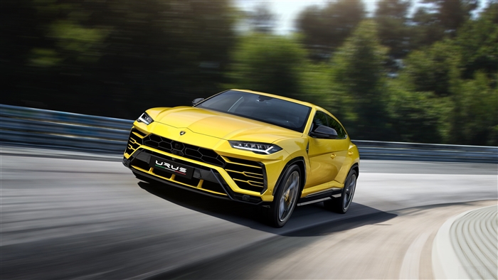 Yellow Lamborghini Urus driving on a track 4K