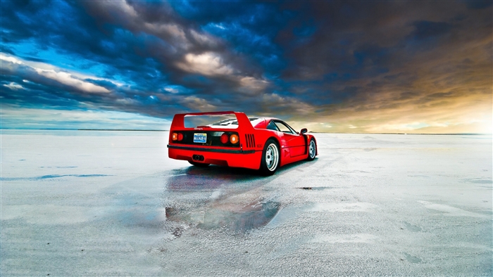 Red Ferrari F40 on wet salt flats