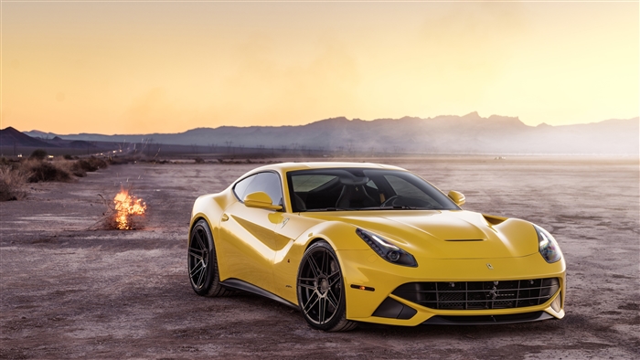 Yellow Ferrari F12 in desert with burning tumbleweed