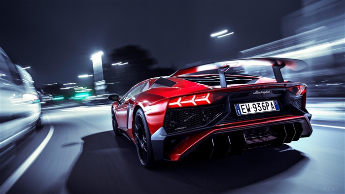 Red Lamborghini Aventador SV driving at night