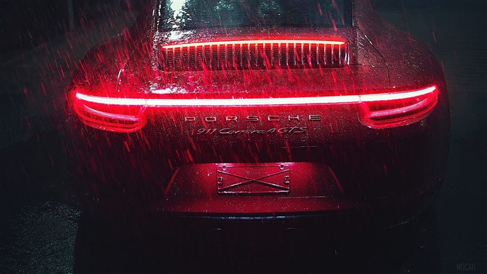 Red Porsche 911 Carrera GTS in the rain