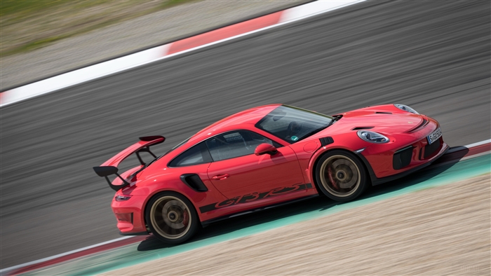 Red 2018 Porsche 911 GT3 RS on a race track