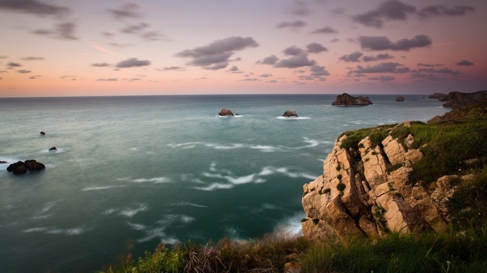 Ocean cliffs at sunset with rock formations