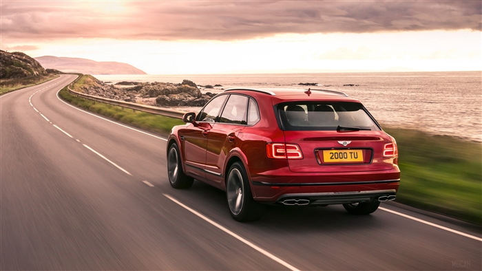 Bentley Bentayga V8 driving on coastal road 4K