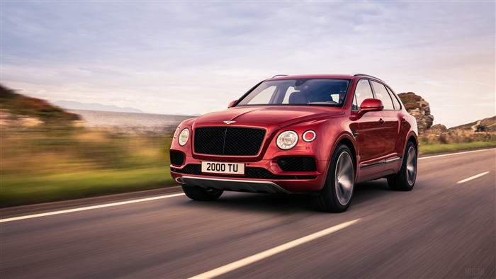 Red 2018 Bentley Bentayga V8 driving on road 4K