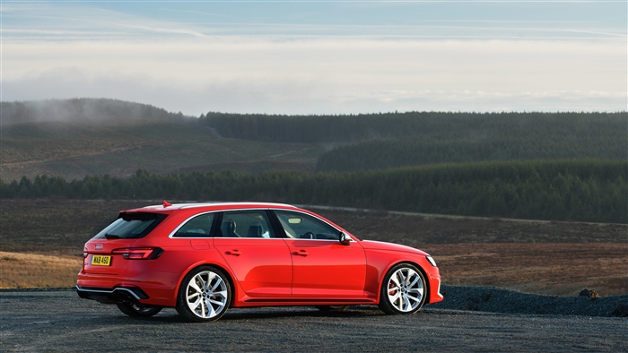 Red Audi RS 4 Avant parked on a hill