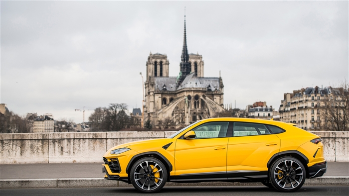 Yellow Lamborghini Urus in Paris with Notre Dame