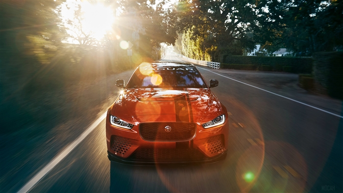 Orange Jaguar XE SV Project 8 driving on road