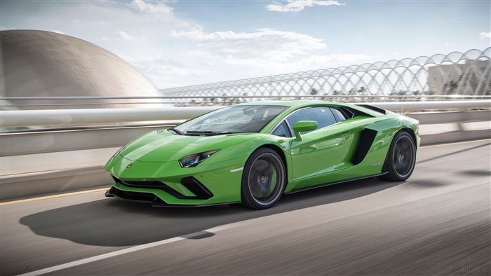 Green Lamborghini Aventador S driving on a road