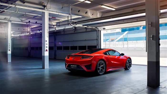 Red Acura NSX in a garage with racetrack background