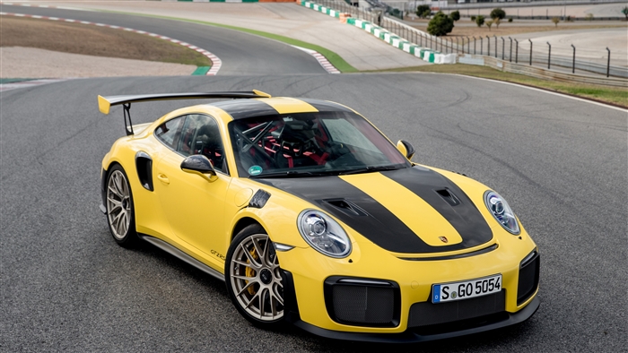 Yellow Porsche 911 GT2 RS on a race track