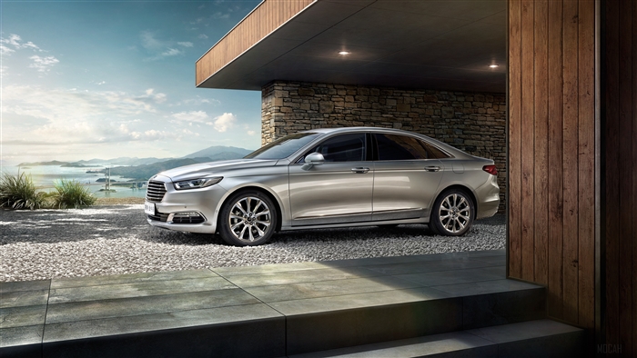 Silver Ford Taurus parked by a modern house