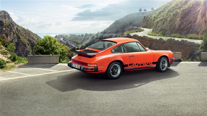 Orange Porsche 911 Carrera on a Mountain Road