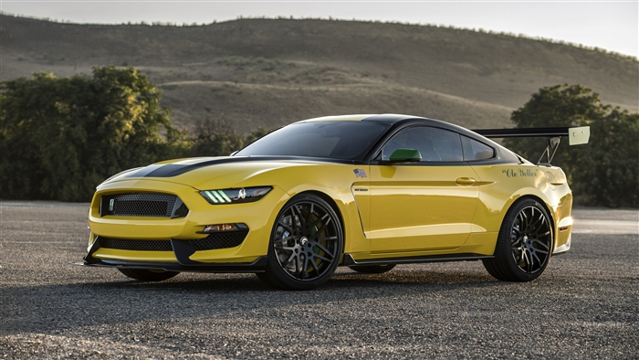 Yellow Ford Mustang GT350 with a large rear spoiler