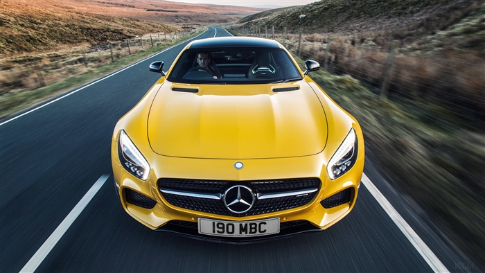 Yellow Mercedes-AMG GT driving on a road