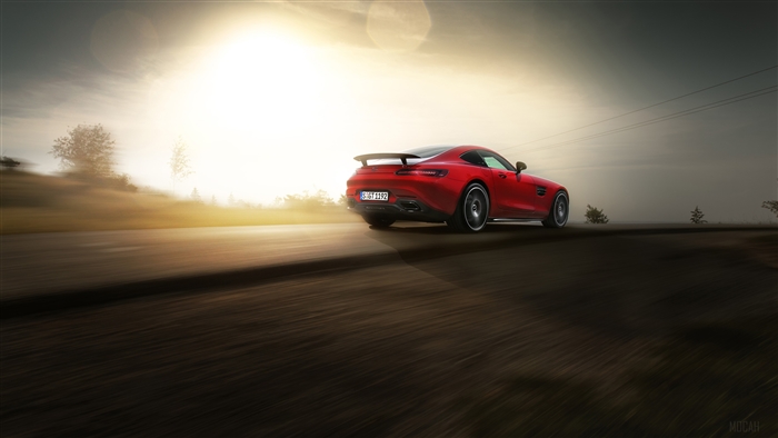 Red Mercedes AMG GTS driving on a road